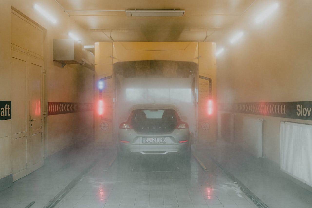mission-img A vehicle inside an automated car wash, surrounded by mist and interior lighting.